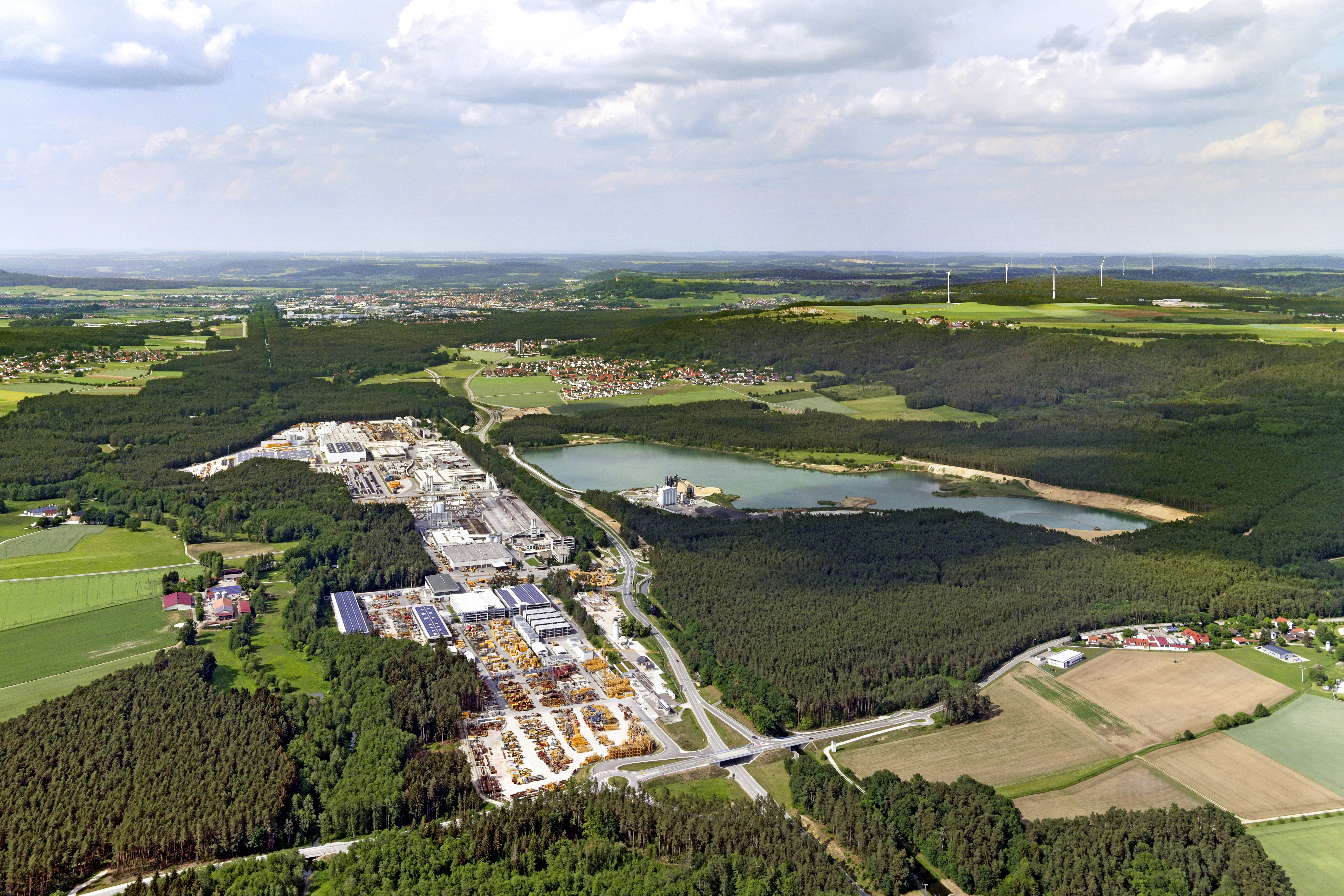 Panoramaaufnahme des gesamten Industriegeländes der Firma Max Bögl mit Blick auf Sengenthal (Vordergrund), Neumarkt in der Oberpfalz (Hintergrund) und den Windenergieanlagen in nordöstlicher Richtung
